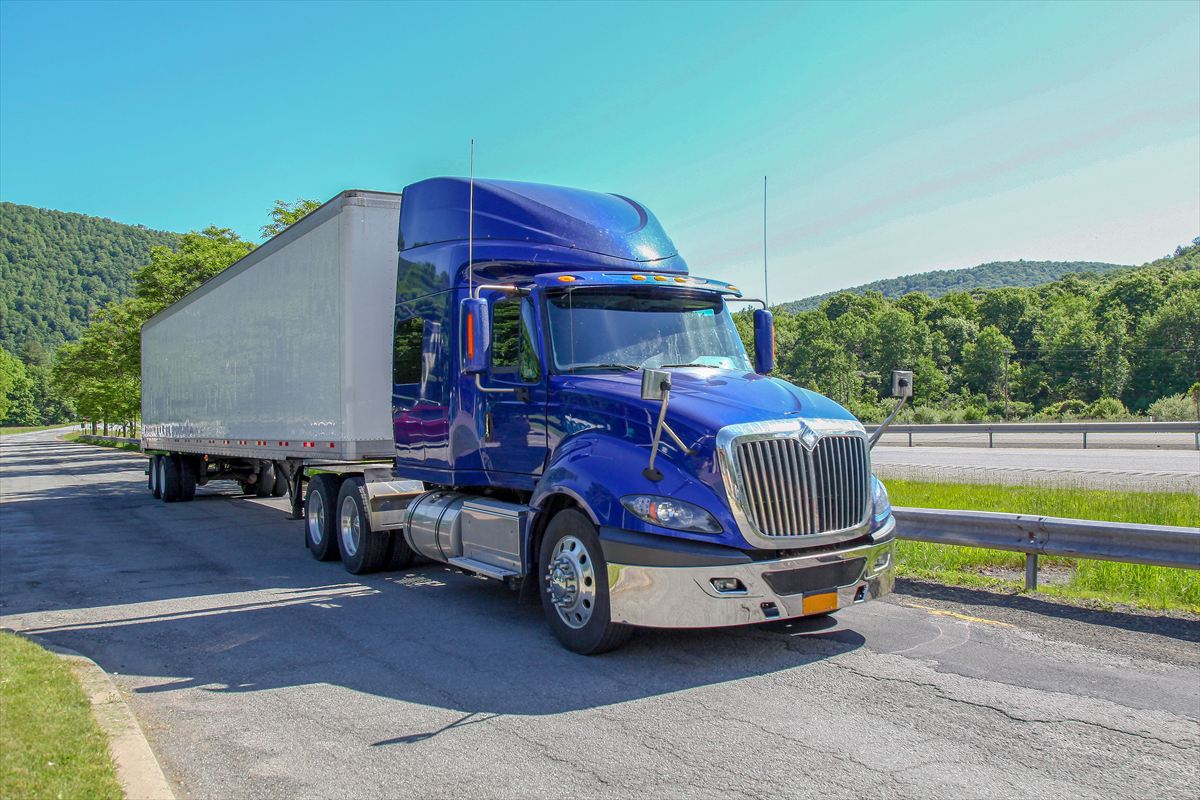 semi truck and trailer on a road